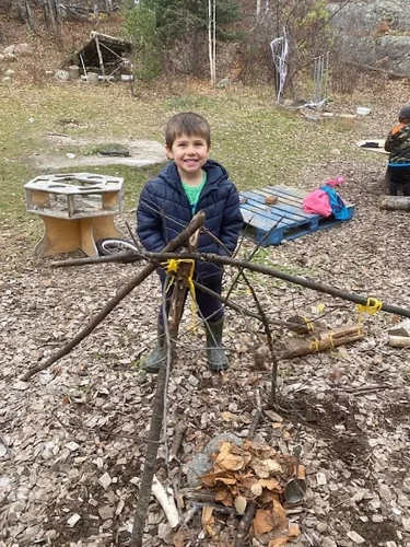 RLMPS student shows off his tree branch building