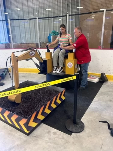 Student tries out a model excavator.