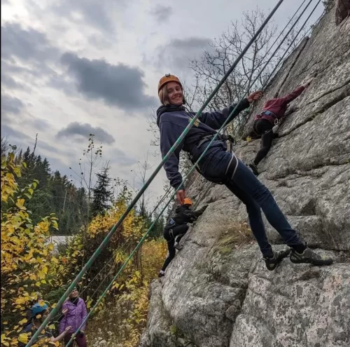 Students rock climbing outdoors.