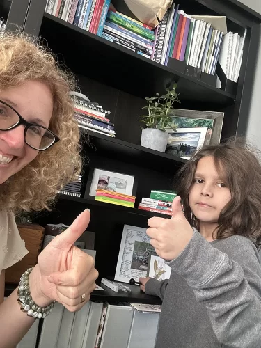 Student and teacher give thumbs up at Golden Learning Centre.